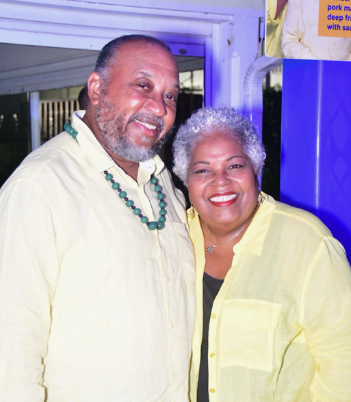 Smiling couple wearing yellow shirts at event
